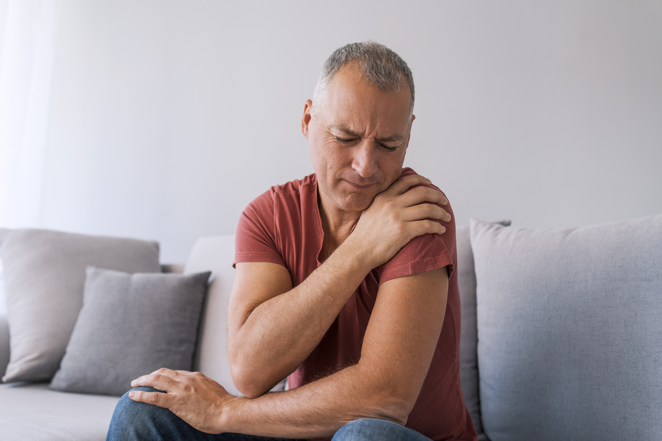 mature man suffering from shoulder pain